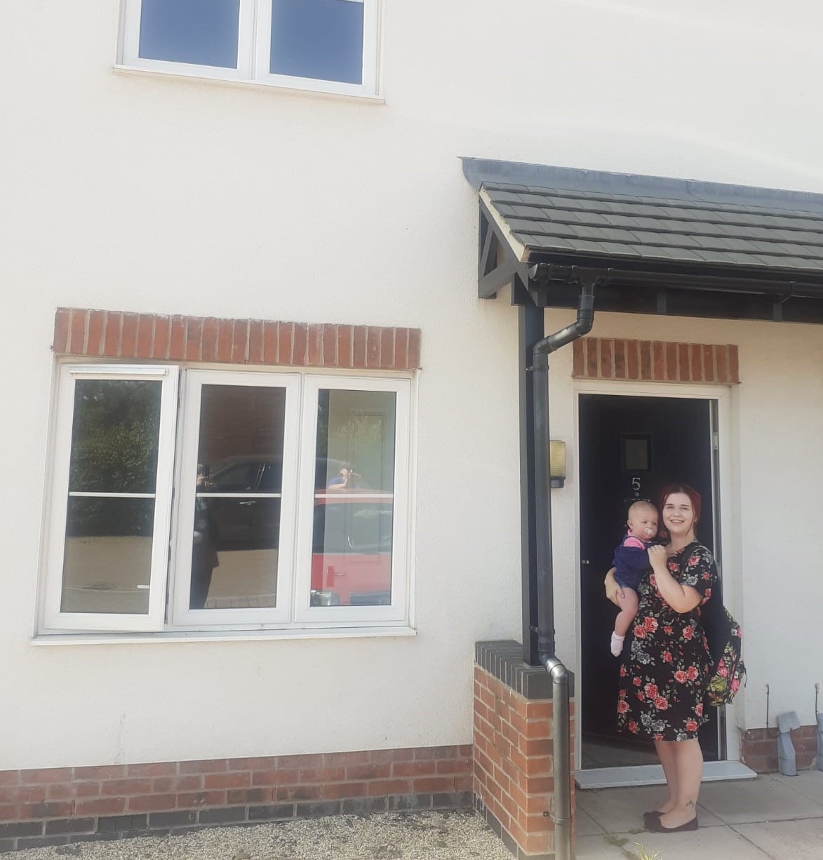 Leanne and daughter outside new home