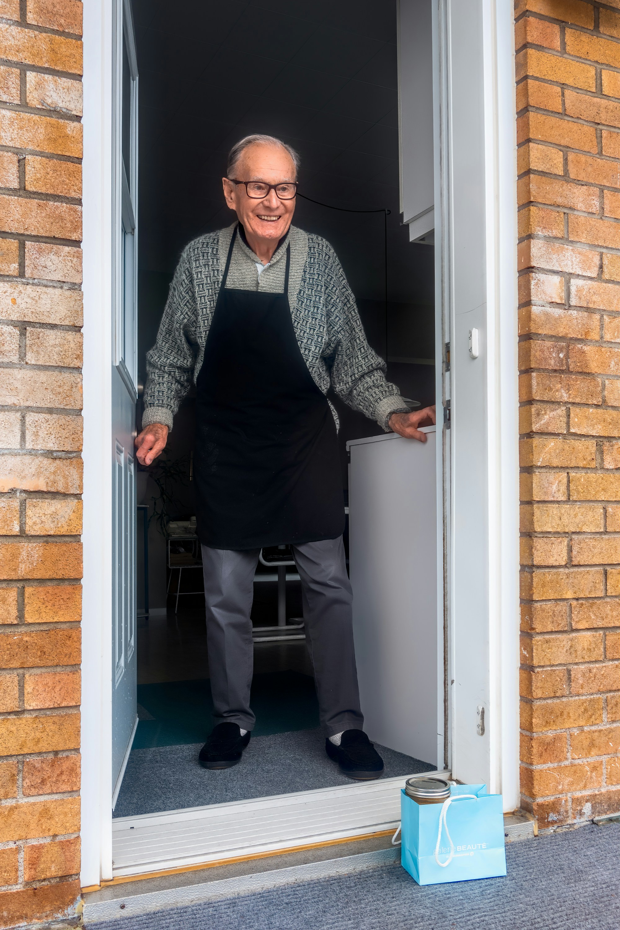 Smiley Older Man Opening Door Andre Ouellet